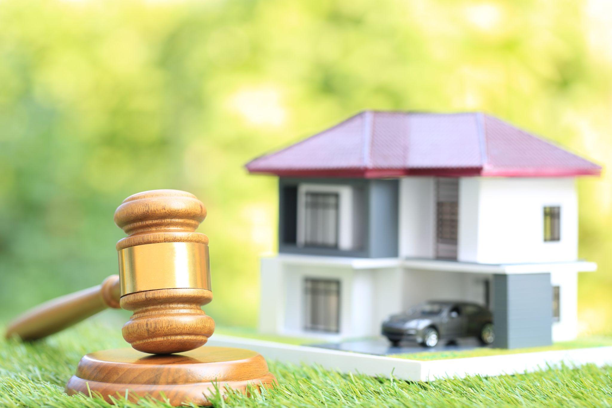 Gavel wooden and model house on natural green background