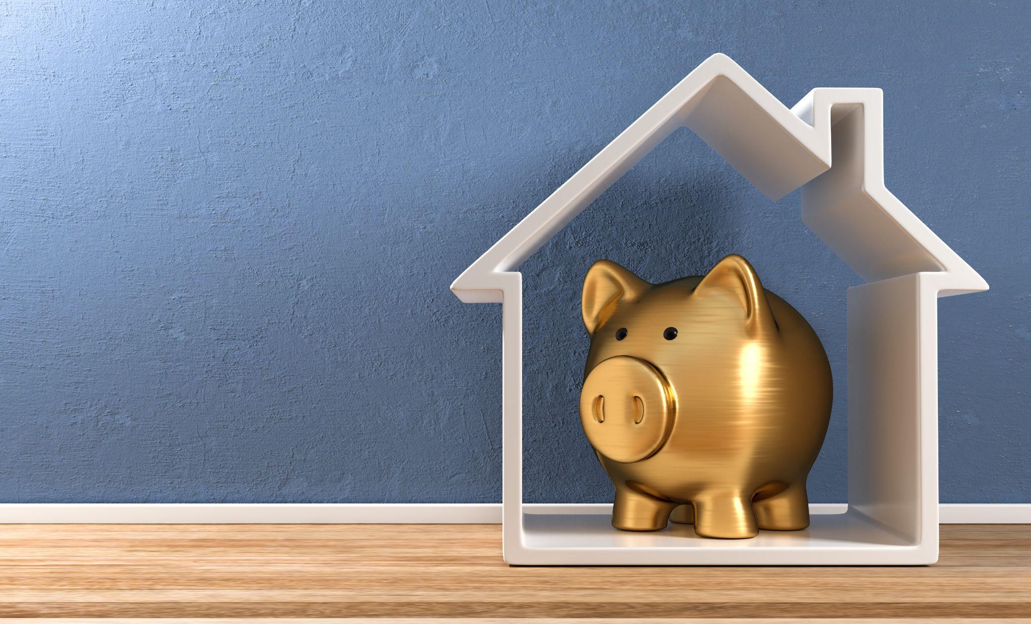 A golden piggy bank in a house symbolises savings and investment.