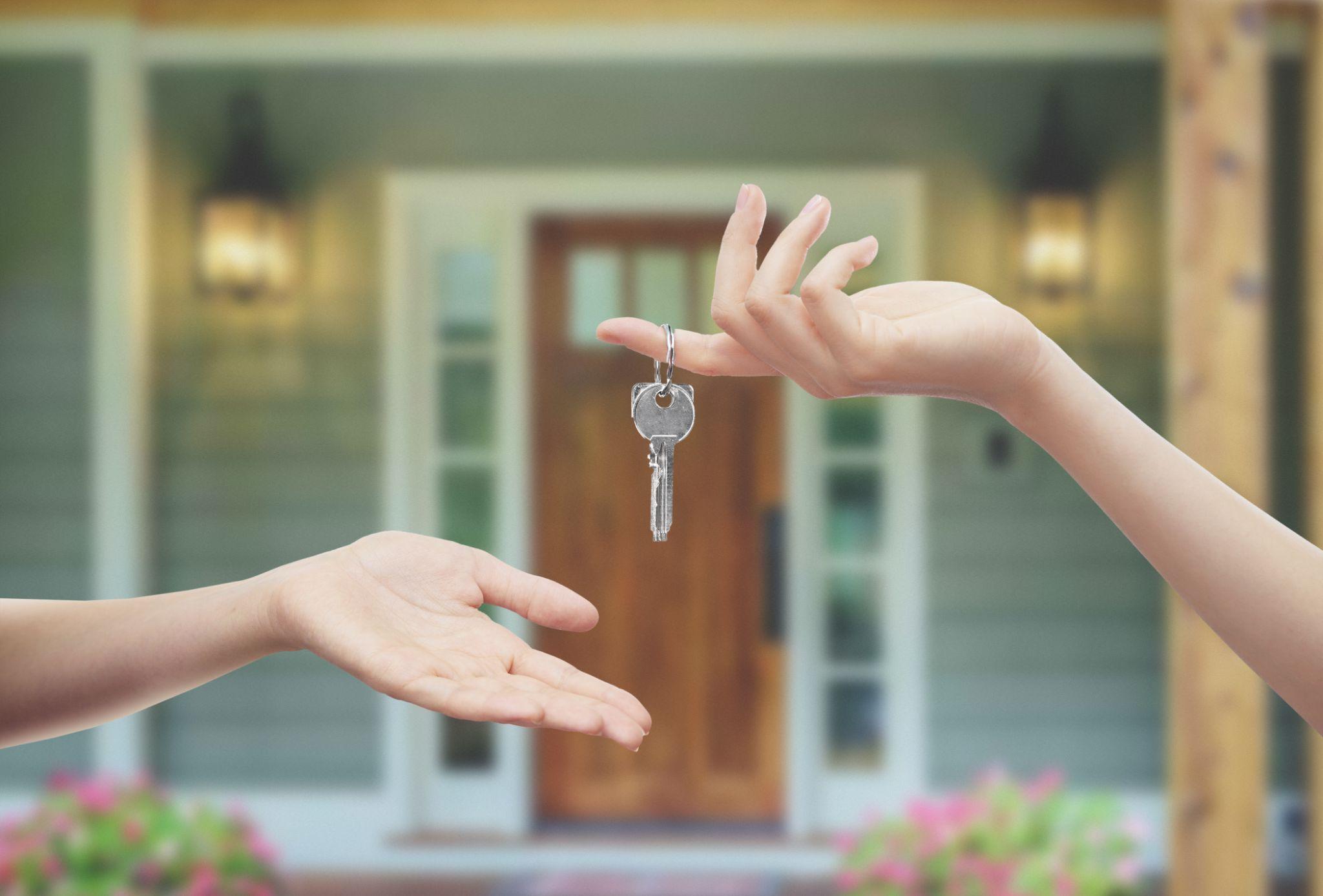 Hands with keys home door background